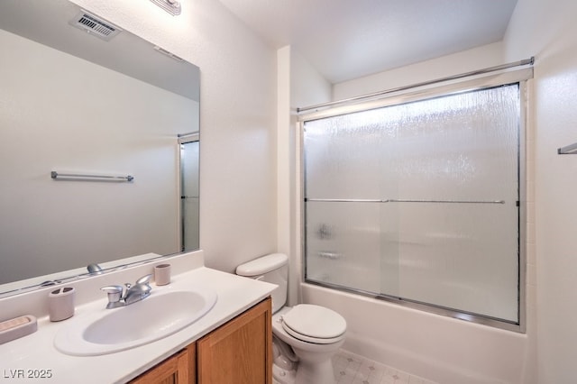 full bathroom featuring toilet, vanity, combined bath / shower with glass door, and visible vents
