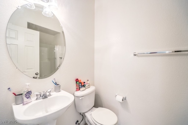 bathroom with toilet and a sink