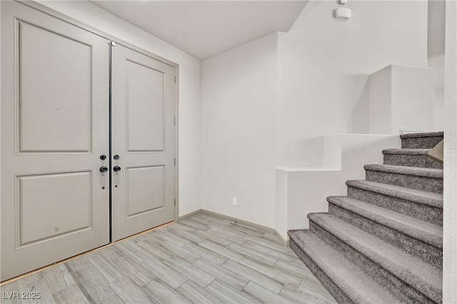 9830 Wild Coyote Ct, Las Vegas, NV 89141 - foyer entrance featuring stairway, light wood finished floors, and baseboards