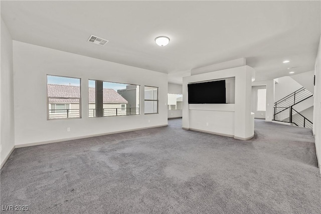 9830 Wild Coyote Ct, Las Vegas, NV 89141 - unfurnished living room featuring carpet, baseboards, stairway, and recessed lighting