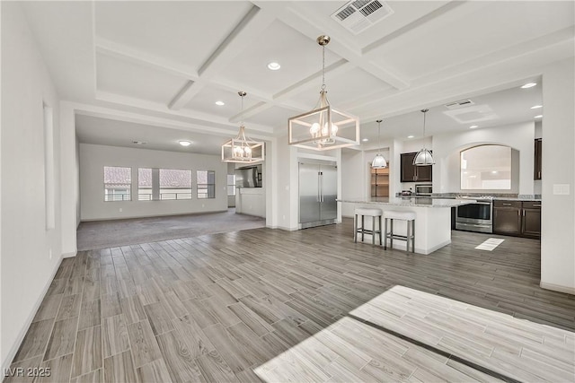 9830 Wild Coyote Ct, Las Vegas, NV 89141 - unfurnished living room with coffered ceiling, wood finished floors, baseboards, a chandelier, and recessed lighting