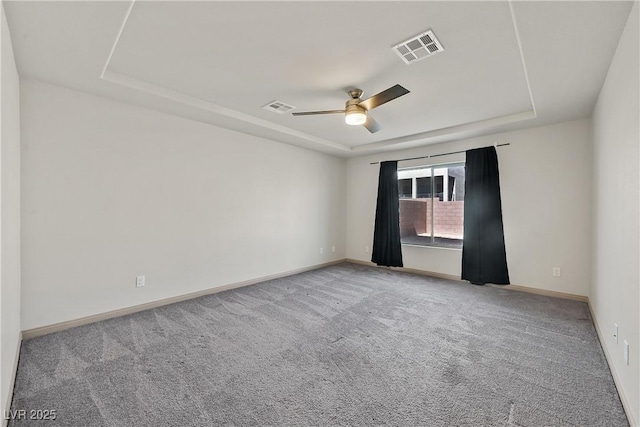9830 Wild Coyote Ct, Las Vegas, NV 89141 - unfurnished room featuring a raised ceiling, carpet flooring, a ceiling fan, and baseboards