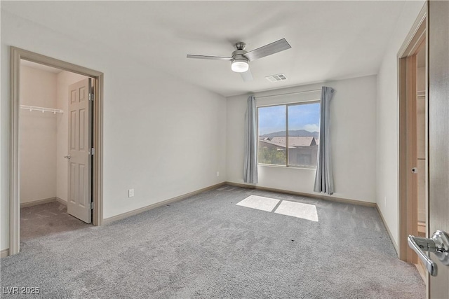 9830 Wild Coyote Ct, Las Vegas, NV 89141 - unfurnished bedroom featuring carpet, a walk in closet, baseboards, ceiling fan, and a closet
