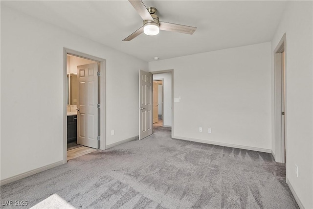 9830 Wild Coyote Ct, Las Vegas, NV 89141 - unfurnished bedroom featuring light carpet, baseboards, ceiling fan, and ensuite bathroom