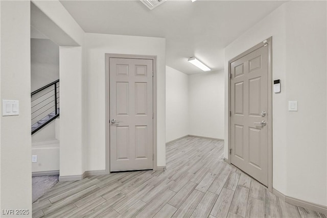 9830 Wild Coyote Ct, Las Vegas, NV 89141 - unfurnished room with light wood-style flooring, baseboards, and stairs