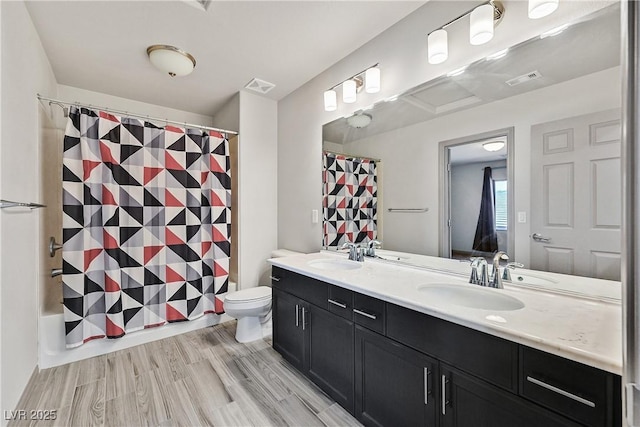 9830 Wild Coyote Ct, Las Vegas, NV 89141 - bathroom featuring double vanity, toilet, and wood finished floors