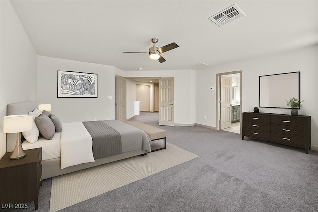 9830 Wild Coyote Ct, Las Vegas, NV 89141 - bedroom featuring carpet, baseboards, ceiling fan, and ensuite bathroom