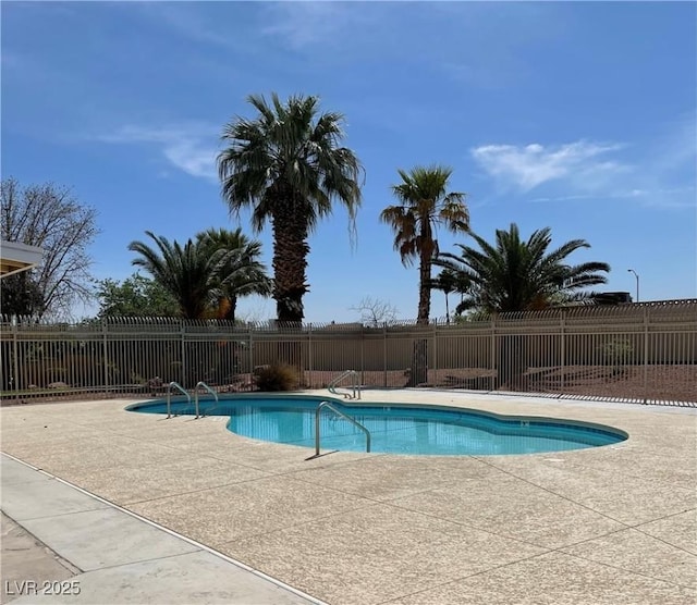 community pool featuring a patio area and fence