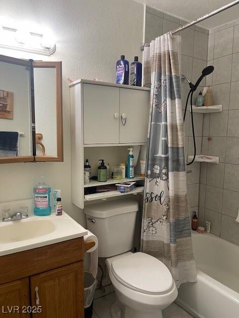 full bathroom featuring shower / bathtub combination with curtain, vanity, and toilet