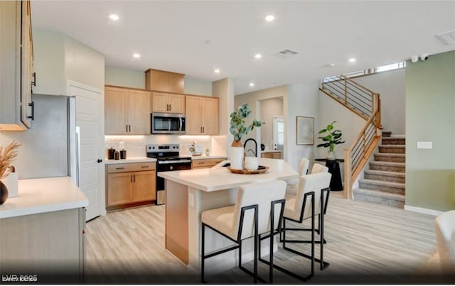 312 Parawan St Lot 12, Henderson, NV 89015 - kitchen with light countertops, stainless steel appliances, a center island with sink, light brown cabinets, and backsplash