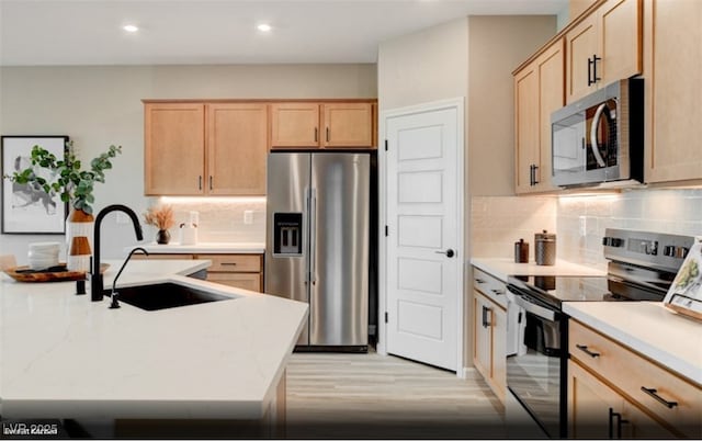 312 Parawan St Lot 12, Henderson, NV 89015 - kitchen featuring light wood-style flooring, tasteful backsplash, light brown cabinets, appliances with stainless steel finishes, and a sink