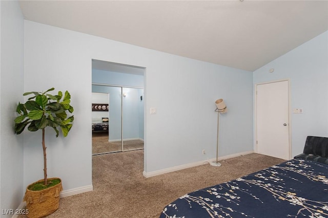 bedroom featuring carpet, lofted ceiling, and baseboards