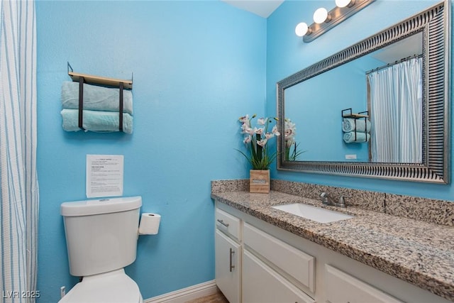 bathroom with vanity, toilet, and a shower with curtain