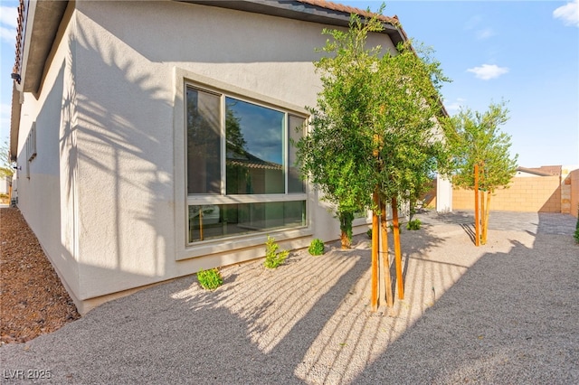 31 Autumn Palm Ave, Henderson, NV 89011 - view of side of property with stucco siding and fence