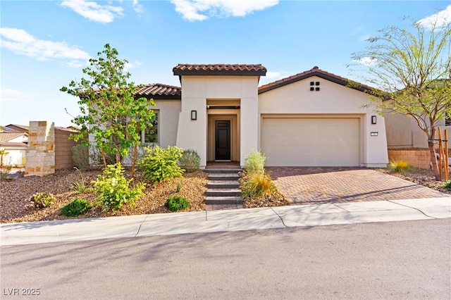 31 Autumn Palm Ave, Henderson, NV 89011 - mediterranean / spanish-style home with stucco siding, decorative driveway, an attached garage, and a tile roof