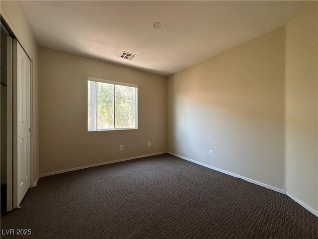 6080 Golden Corral Trl Unit 103, Henderson, NV 89011 - unfurnished bedroom with dark colored carpet and baseboards
