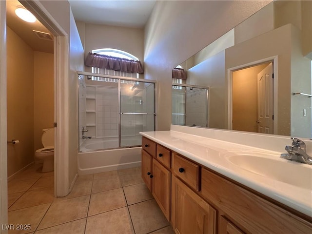 6080 Golden Corral Trl Unit 103, Henderson, NV 89011 - bathroom featuring toilet, tile patterned flooring, vanity, and bath / shower combo with glass door