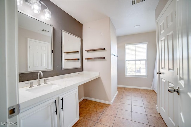 bathroom with tile patterned flooring, vanity, baseboards, and visible vents