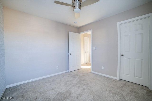 unfurnished bedroom featuring baseboards, carpet flooring, and a ceiling fan