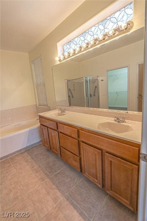 bathroom featuring a stall shower, double vanity, a bath, and a sink