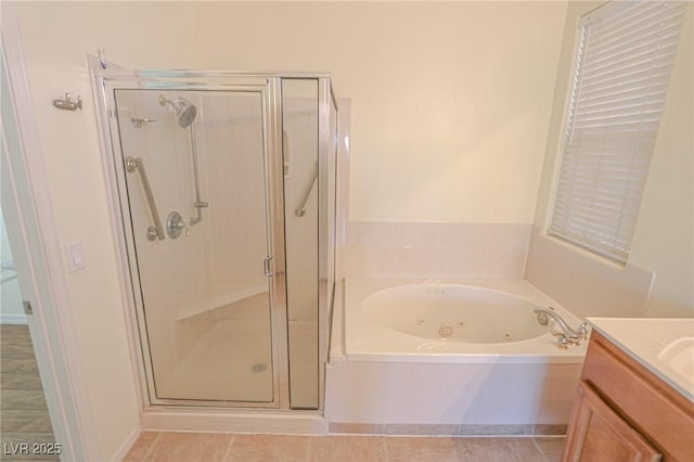bathroom featuring tile patterned floors, vanity, a whirlpool tub, and a shower stall