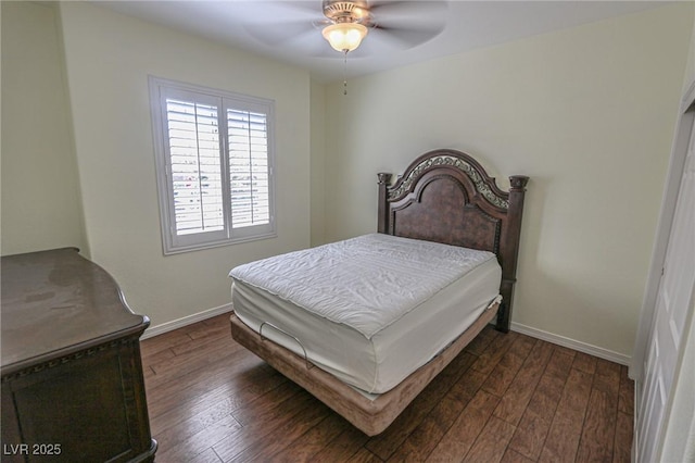 bedroom with dark wood-type flooring, ceiling fan, and baseboards