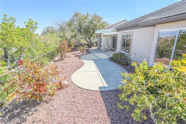 view of yard with a pergola, fence, and a patio area