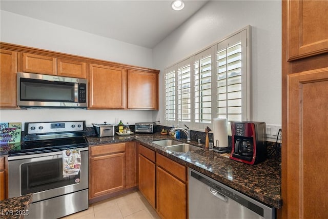 5224 E San Palo Dr, Pahrump, NV 89061 - kitchen featuring a sink, dark stone countertops, appliances with stainless steel finishes, and brown cabinets