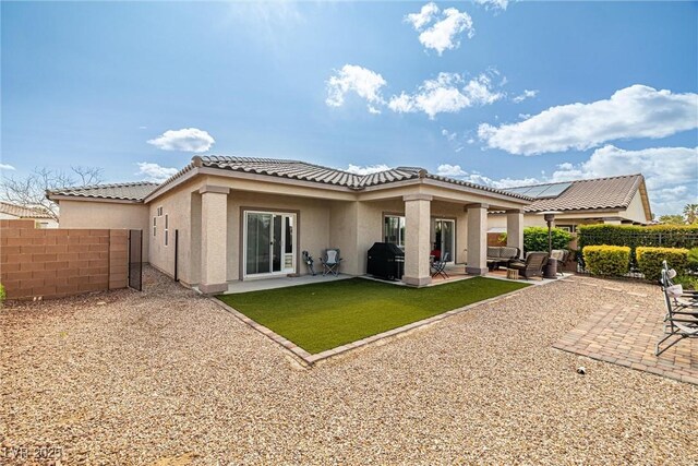 5224 E San Palo Dr, Pahrump, NV 89061 - back of property featuring a patio, a fenced backyard, a lawn, a tile roof, and stucco siding