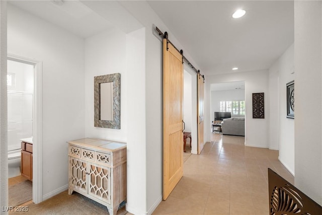 5224 E San Palo Dr, Pahrump, NV 89061 - hallway featuring baseboards, a barn door, recessed lighting, and light tile patterned floors