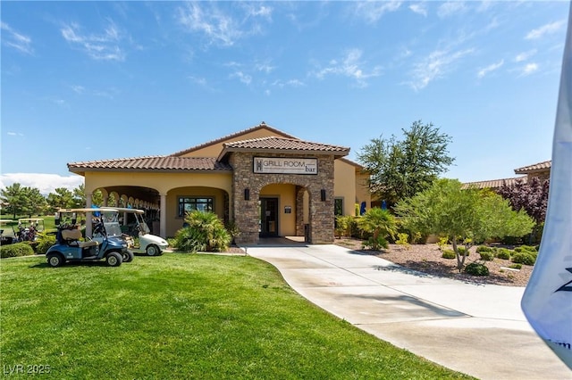 5224 E San Palo Dr, Pahrump, NV 89061 - mediterranean / spanish house featuring stone siding, a tile roof, stucco siding, and a front lawn