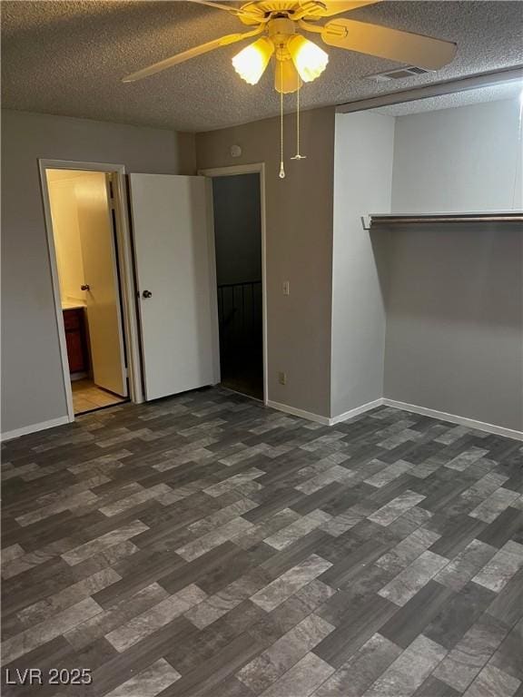 2541 Love St, Las Vegas, NV 89121 - unfurnished bedroom featuring wood finished floors, baseboards, a textured ceiling, ensuite bath, and ceiling fan