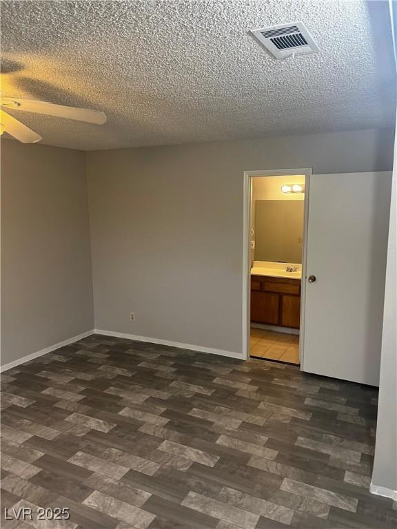 2541 Love St, Las Vegas, NV 89121 - unfurnished room featuring dark wood-type flooring, ceiling fan, baseboards, and a textured ceiling