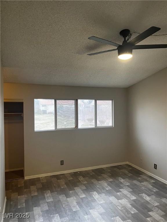 2541 Love St, Las Vegas, NV 89121 - unfurnished bedroom with a textured ceiling, wood finished floors, baseboards, a closet, and a ceiling fan