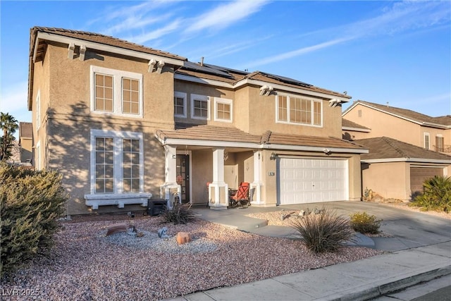 9578 Teton Vista Ave, Las Vegas, NV 89117 - view of front of property featuring stucco siding, a garage, concrete driveway, and roof mounted solar panels