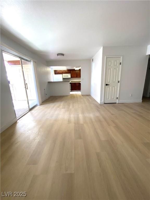 4421 Alexis Dr Unit 429, Las Vegas, NV 89103 - unfurnished living room featuring light wood-style flooring and baseboards