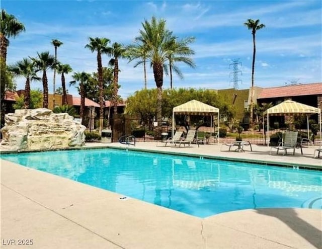 pool with a gazebo, a patio area, and fence