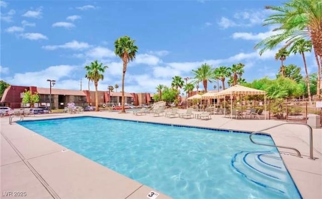 pool featuring a patio area and fence