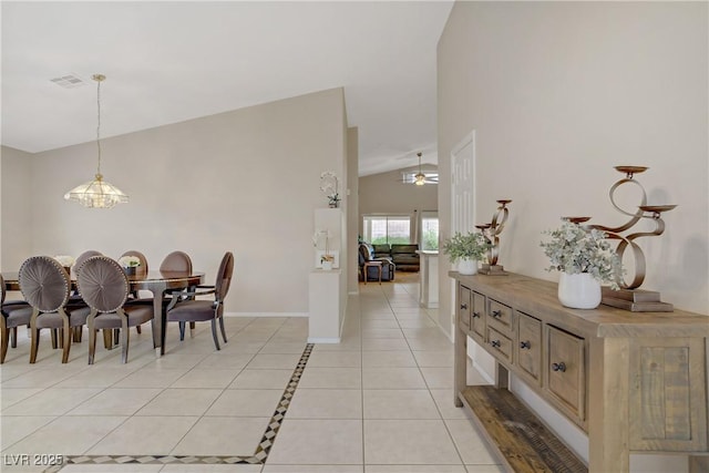 dining area featuring visible vents, baseboards, lofted ceiling, ceiling fan with notable chandelier, and light tile patterned floors