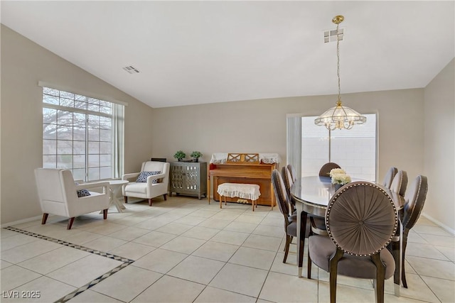 dining space featuring light tile patterned flooring, visible vents, lofted ceiling, and an inviting chandelier
