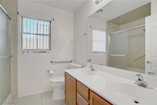 full bathroom featuring a shower with shower door, a sink, tile patterned floors, and toilet