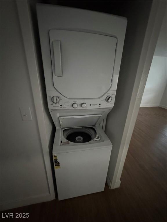 4300 N Lamont St Unit 225, Las Vegas, NV 89115 - laundry room with stacked washer / dryer, wood finished floors, and baseboards