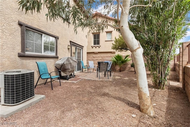 view of patio / terrace with cooling unit, grilling area, and a fenced backyard