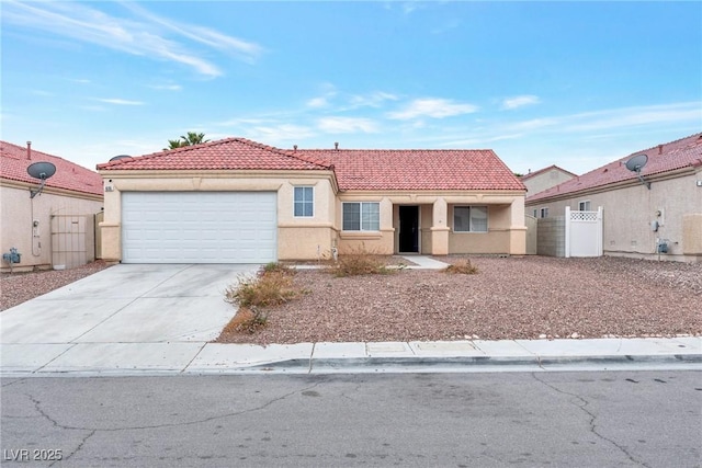 view of front of property with a tile roof, stucco siding, fence, an attached garage, and driveway
