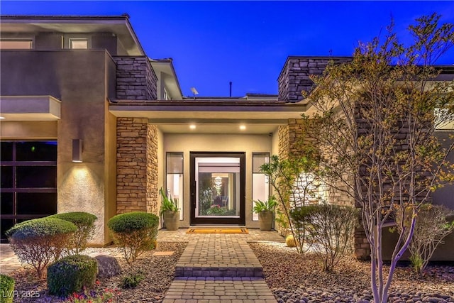 10 Sugarberry Ln, Las Vegas, NV 89135 - exterior entry at twilight featuring stucco siding and stone siding