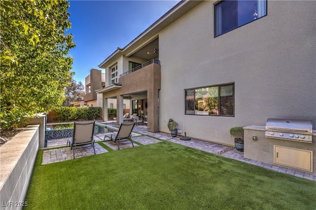 10 Sugarberry Ln, Las Vegas, NV 89135 - view of yard with a balcony, a patio area, and an outdoor kitchen