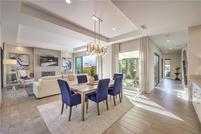10 Sugarberry Ln, Las Vegas, NV 89135 - dining area with a raised ceiling, a large fireplace, a chandelier, light tile patterned flooring, and recessed lighting