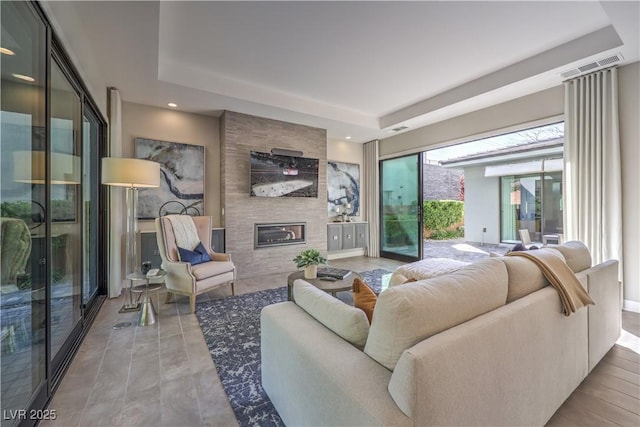 10 Sugarberry Ln, Las Vegas, NV 89135 - living room with a fireplace, a tray ceiling, and recessed lighting