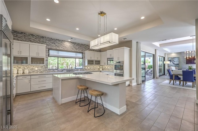 10 Sugarberry Ln, Las Vegas, NV 89135 - kitchen with a raised ceiling, tasteful backsplash, white cabinetry, and recessed lighting