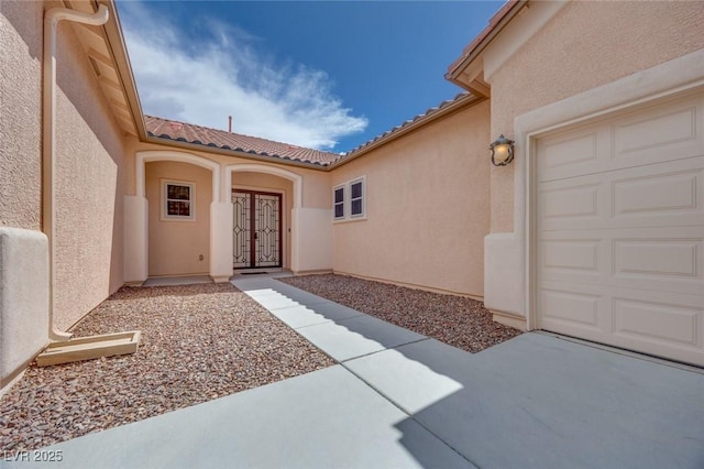 7908 Morning Gallop Ct, Las Vegas, NV 89131 - doorway to property with stucco siding, a tiled roof, french doors, and a garage